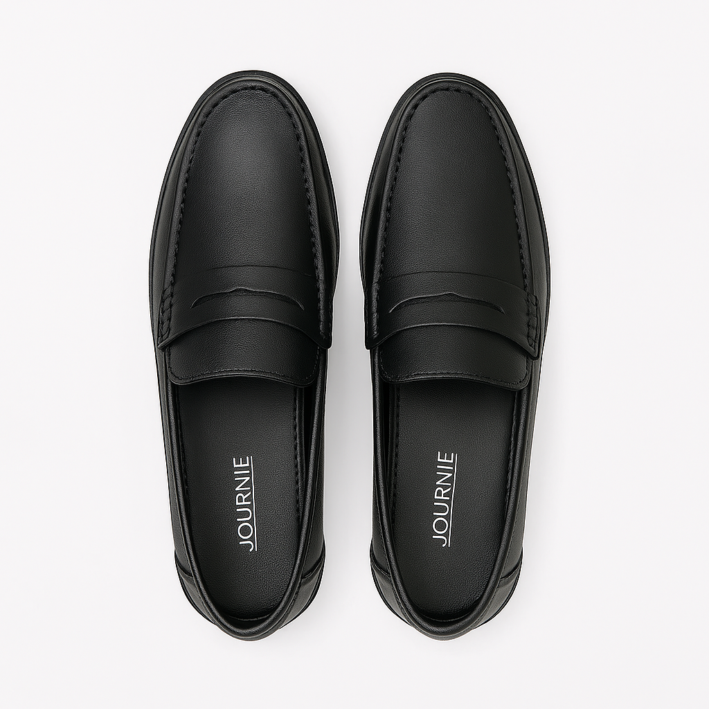 Pair of black loafers with 'Journe' branding on a white background