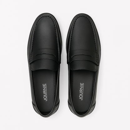 Pair of black loafers with 'Journe' branding on a white background