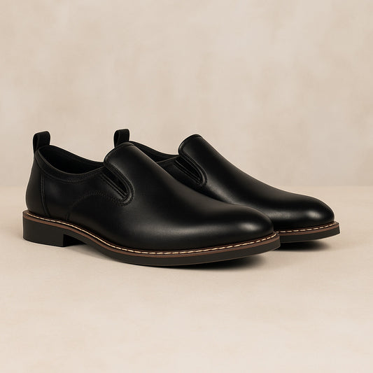 Pair of black leather shoes on a beige background